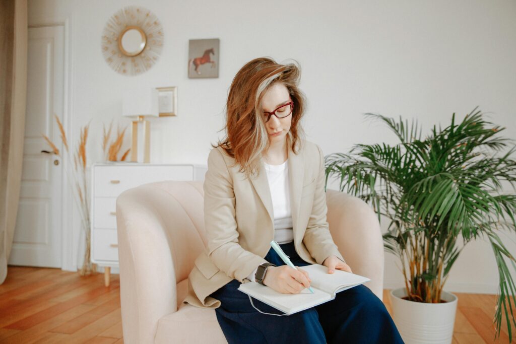 pexels-photo-3958402-3958402-4 A female therapist taking notes during a session in a stylish office setting.